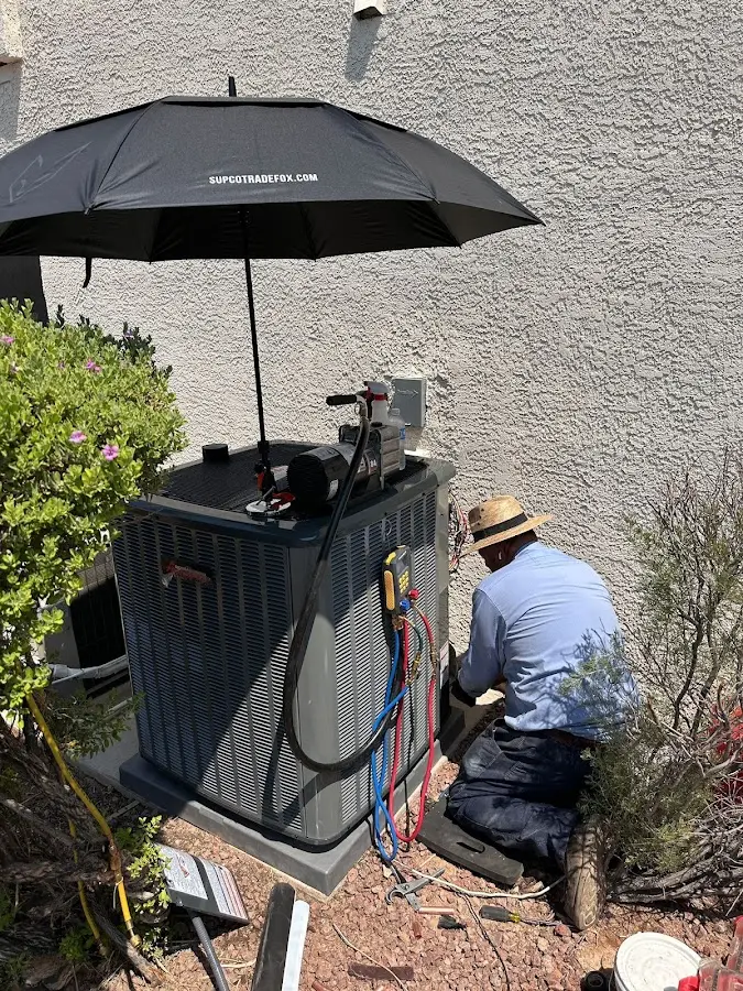 HVAC technician performing outdoor AC maintenance in Webster